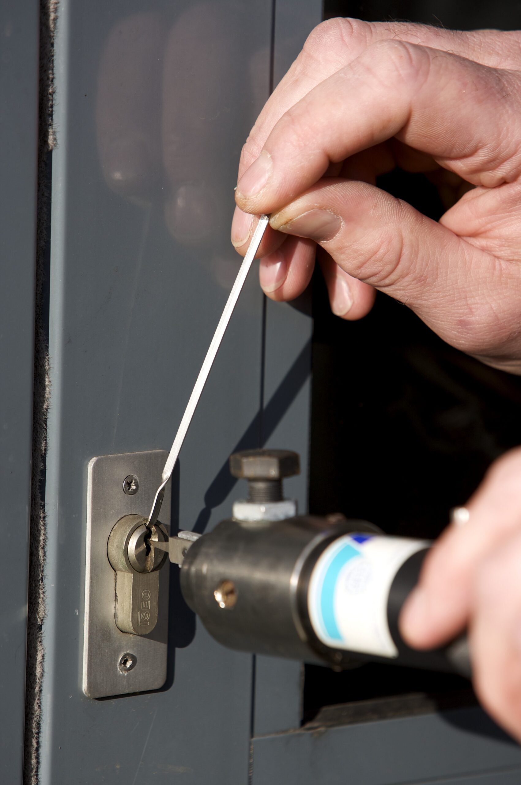 Locksmith repairing a door lock in Thorne